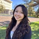 Emma Pham smiling in a grassy lawn